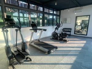 a gym with two exercise bikes and a treadmill at Risco Centro de Bucerías beachfront with pool in Bucerías