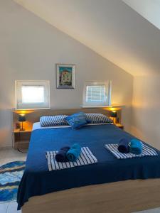 a bedroom with a bed with blue towels on it at Villa Ante Blace in Blace