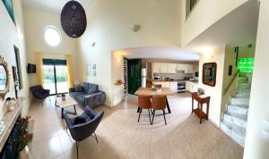 a living room with a couch and a table at THERETRA KIOTARI VILLAS in Gennadi +29 photos