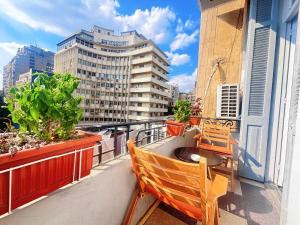 a balcony with two chairs and a view of a city at Bisan hostel in Cairo