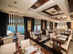 a restaurant with tables and chairs in a room at Fiammanti Hotel Montenegro in Herceg-Novi