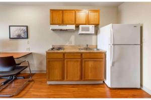 a kitchen with a white refrigerator and a sink at Studio 6 Extended Stay Birmingham Pelham AL in Pelham +17 photos