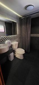 a bathroom with two toilets and a sink and a mirror at Morada Luna Coyoacán in Mexico City