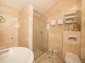 a bathroom with a shower and a toilet and a sink at Fiammanti Hotel Montenegro in Herceg-Novi