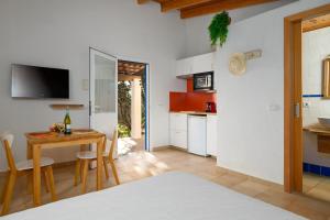 a kitchen and a dining room with a table and a kitchen at Casa Garrover - Calma entre Sabinas in Illes Balears