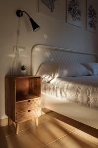 a bedroom with a bed with a nightstand and a lamp at Casa Garrover - Calma entre Sabinas in Illes Balears