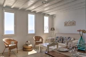 a living room with a couch and chairs at La Maison Blanche in Agios Stefanos