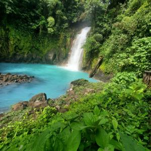 a waterfall in the middle of a river at Auralta Rio Celeste I Elohi Collection in Rio Celeste