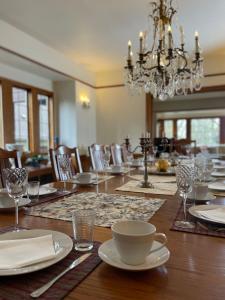 a dining room with a table with a chandelier at Cecil Bacon Manor in Seattle +56 photos