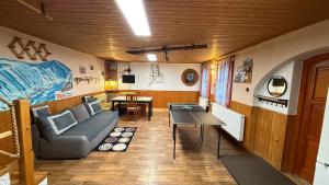 a living room with a couch and a table at Domeček Karlov in Malá Morávka