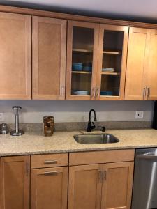 a kitchen with wooden cabinets and a sink at Downtown house w on-site parking walk to museums, US Capital Scap in Washington, D.C.