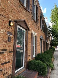 a brick building with a door on the side of it at Downtown house w on-site parking walk to museums, US Capital Scap in Washington, D.C.
