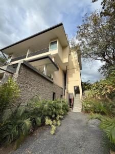 a house with a staircase leading up to it at Isabel 203 Space, light and calm! in Nicoya