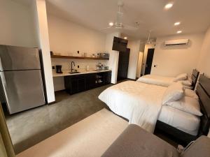 a large room with two beds and a kitchen at Isabel 203 Space, light and calm! in Nicoya +12 photos