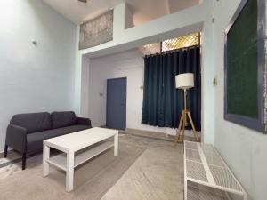 a living room with a couch and a table at Nook Coliving Male Only in Lucknow