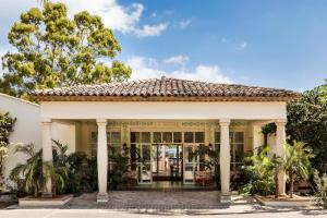 an old house with a porch and columns at Hôtel La Tartane Saint-Tropez in Saint-Tropez