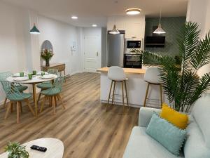 a living room and kitchen with a table and a couch at El rincón de armanyá in Lugo +22 photos