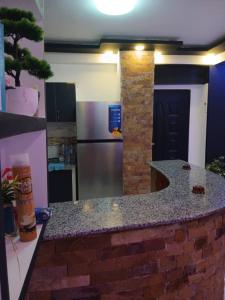 a kitchen with a stone counter top in a room at Appartement Saket Plage in Taranimt +4 photos