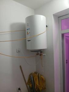 a water heater on the wall of a room at Appartement Saket Plage in Taranimt