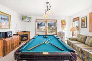 a living room with a pool table at 6151 - Once Upon a Tide in Nags Head
