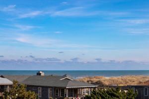a house with the ocean in the background at 6151 - Once Upon a Tide in Nags Head