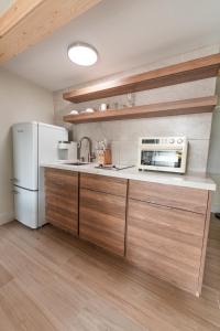 a kitchen with a white refrigerator and a microwave at Seahorse Beach Bungalows in Fort Pierce