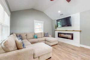 a living room with a couch and a fireplace at Mardi Gras Parade, Walk to Beach! Bay St Louis Gem in Bay Saint Louis