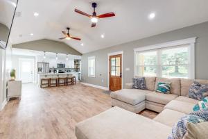 a living room with a couch and a ceiling fan at Mardi Gras Parade, Walk to Beach! Bay St Louis Gem in Bay Saint Louis