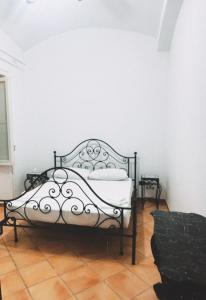 a bedroom with a bed in a white room at Antico Casale Ventotene in Ventotene