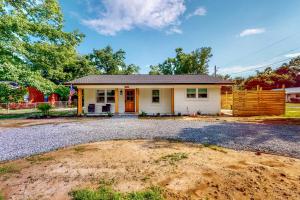 a house with a gravel driveway in front of it at Mardi Gras Parade, Walk to Beach! Bay St Louis Gem in Bay Saint Louis