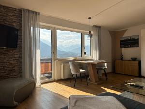 a living room with a table and a large window at Ferienwohnung Bergidyll in Schönau am Königssee