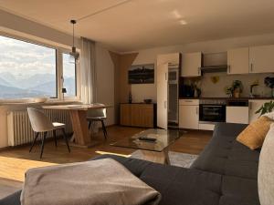a living room and kitchen with a couch and a table at Ferienwohnung Bergidyll in Schönau am Königssee +39 photos