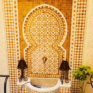 a tiled wall with a sink in a bathroom at Apartment 7 minutes walk from Menara Airport in Marrakesh +34 photos