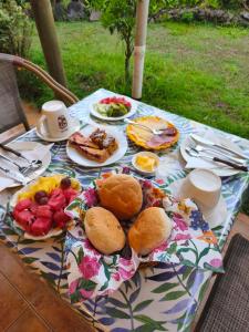 a table with plates of food on top of it at Hostal Uruhao in Hanga Roa