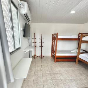 a room with two bunk beds and a window at Anexo - Pousada Canaã in Recife