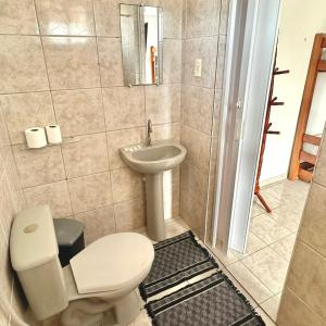 a bathroom with a toilet and a sink at Anexo - Pousada Canaã in Recife