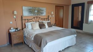 a bedroom with a large bed with a wooden headboard at Ambelli Villa 4 Bedroom Luxury Villa in Skarinou +33 photos