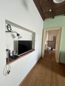 a living room with a flat screen tv on a wall at Casa La Torretta in Ceva