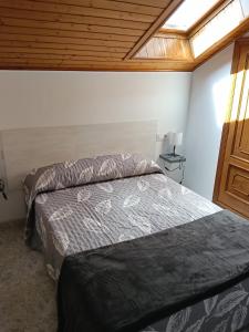 a bedroom with a bed in a room with a window at Rías Baixas in Villanueva de Arosa