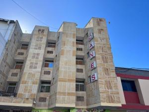 a building with a sign on the side of it at Hotel Danes Barranquilla in Barranquilla