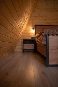 a bedroom with a bed and a table in a attic at Skala House in Skole