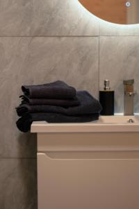 a pile of towels sitting on top of a bathroom sink at Skala House in Skole +31 photos