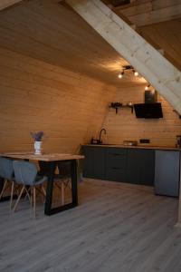 a room with a wooden ceiling with a table at Skala House in Skole