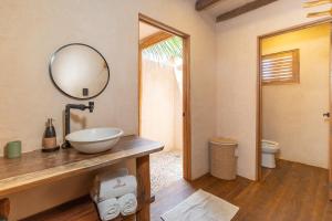 a bathroom with a bowl sink and a mirror at Mangle Rojo Palafitos in La Manzanilla +62 photos