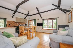 a living room with a couch and a table at Tumrose Cottage in Blisland