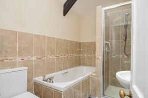 a bathroom with a tub and a toilet and a sink at Tumrose Cottage in Blisland +12 photos