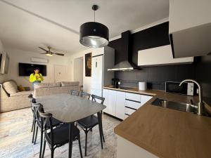 a kitchen and living room with a table and chairs at Casita Machado in Úbeda +18 photos