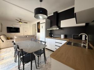 a kitchen and living room with a table and chairs at Casita Machado in Úbeda