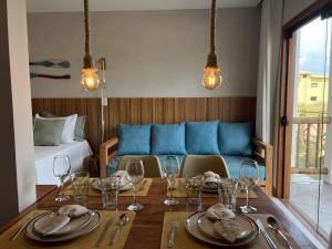 a dining room with a table and a bed at Sol de Marau - Taipu de Fora - próximo das piscinas naturais in Marau