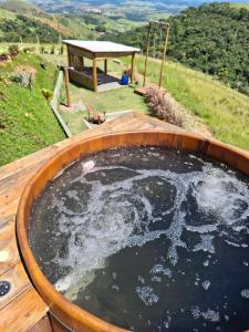 a large pool of water in a wooden tub at Cabana Quatro Estações - Luxo Romântica e com vista incrível in Paty do Alferes